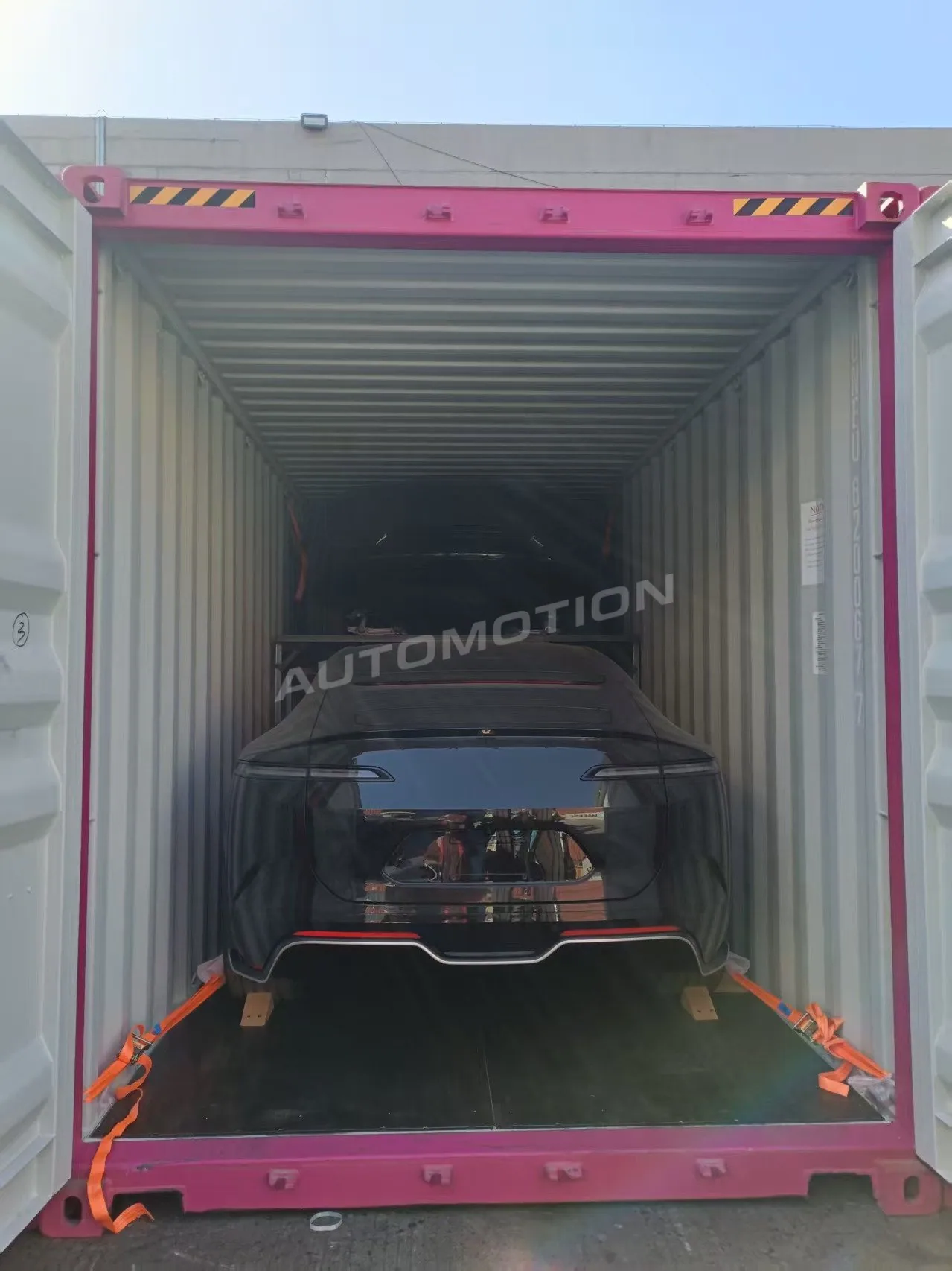 Delivery photograph 13 of 24, a vehicle loaded in a shipping container